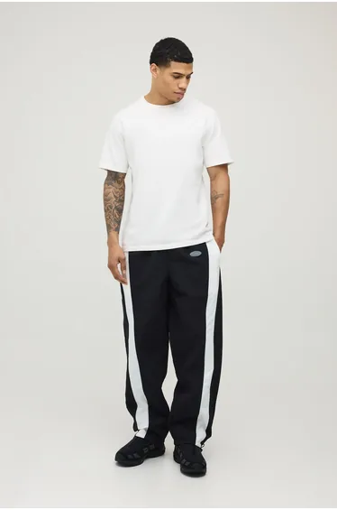 Relaxed Fit Curve Panel and Binding Toggle Hem Nylon Trousers - black