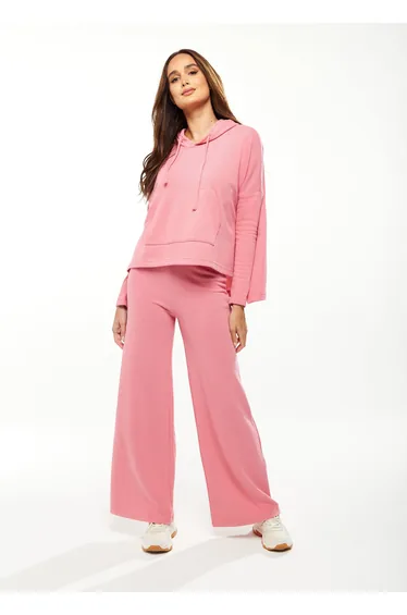 Women's Oversized Hooded Sweatshirt with Front Pocket in Pink.