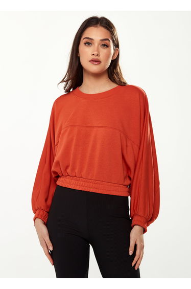 Women's Cropped Sweatshirt in Dark Orange with Voluminous Bat and Balloon Sleeves.