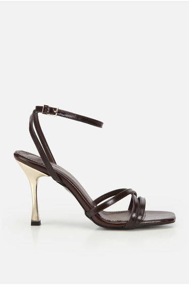 Woman's brown cross-strapped high heels with gold heel