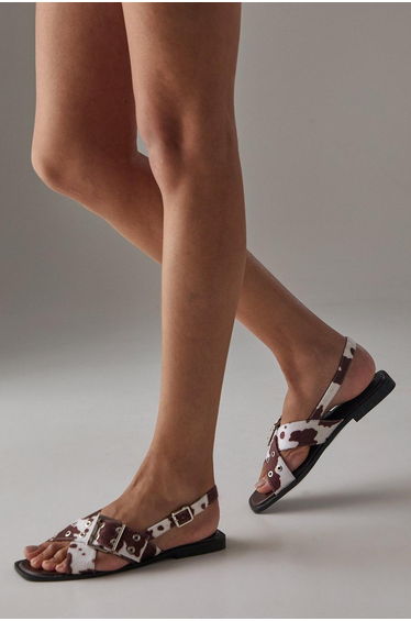 Faith: Mela Cowprint Faux Ponyskin Cross Strap Buckle Detail Slingback Flat Sandals