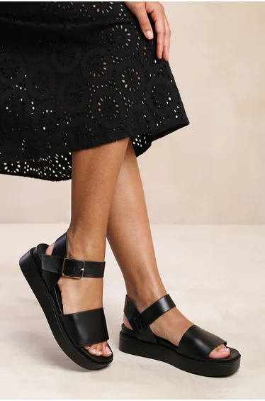 PHOENIX WIDE FIT CLASSIC FLAT SANDALS WITH STRAP AND BUCKLE DETAIL IN BLACK FAUX LEATHER